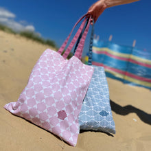 Load image into Gallery viewer, A tote bag with a pink re[eat shell pattern and a tote bag with a blue repeat fish pattern